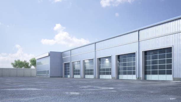 Row of aluminum and glass overhead doors on a commercial metal building