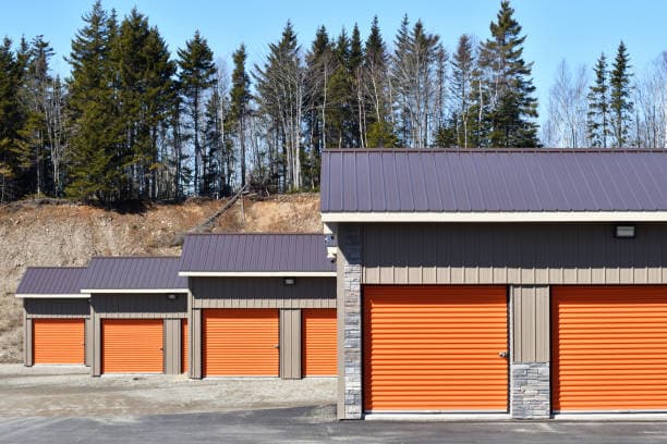 Orange roll-up sheet doors on a row of self-storage units