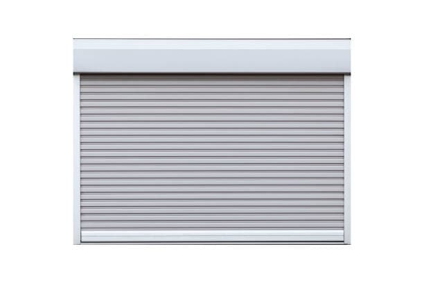 Gray rolling steel shutter door with a header housing