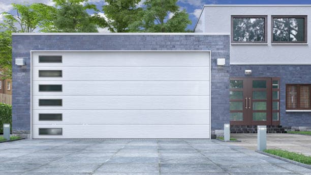 Modern white sectional steel garage door with narrow horizontal windows on a contemporary home